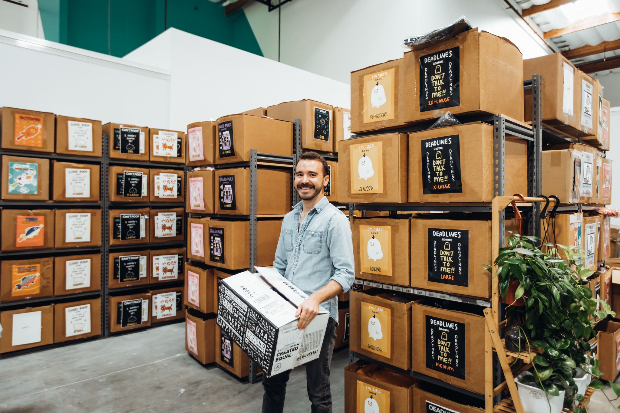 A man holding box in a warehouse